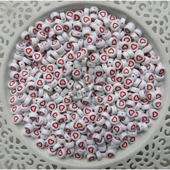Piros keretes akril szív gyöngy  7x4 mm